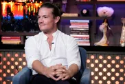 Gary King in a white shirt, smirking on Watch What Happens Live