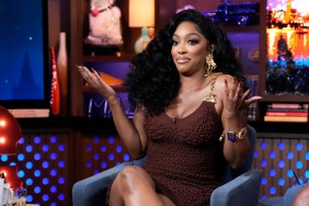 Porsha Williams shrugging her shoulders, wearing a brown dress on Watch What Happens Live
