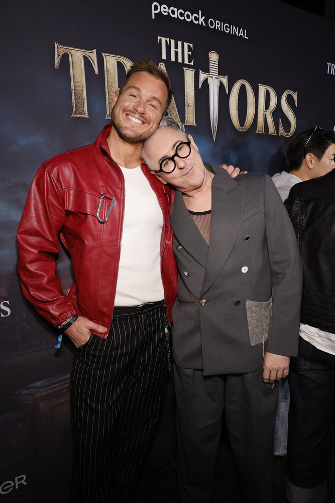Alan Cumming posing with Colton Underwood at the Season 4 premiere of Traitors